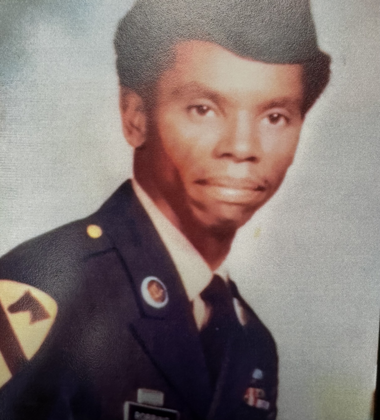 Mr. Robbins poses for his headshot. On his shoulder, he proudly displays the 1st Calvary insignia